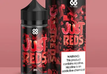 E-liquid bottle and box labeled "Just Reds," with a nicotine warning on a pink background.